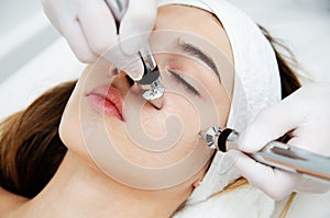 Woman getting ultrasound face beauty treatment in medical spa center