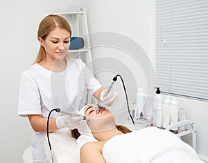 Woman getting ultrasound face beauty treatment in medical spa center