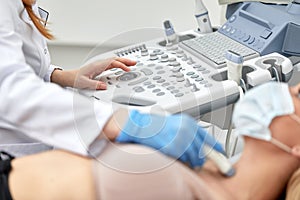 woman getting ultrasound of a thyroid from doctor