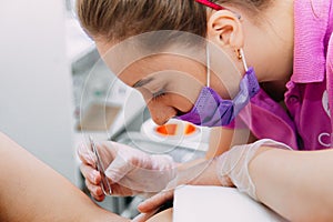 Woman getting wax epilation in salon