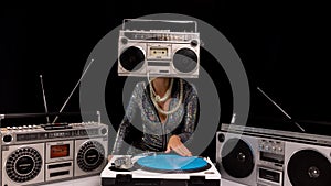 Woman with ghettoblaster as a head Djing