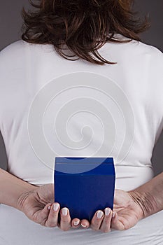 Woman with a gift behind her back