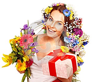 Woman with gift box and flower bouquet .