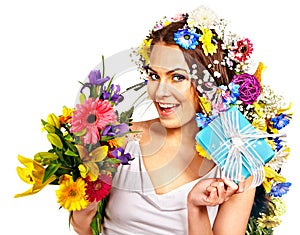 Woman with gift box and flower bouquet .