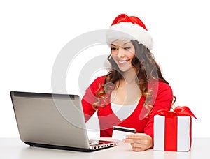 Woman with gift, laptop computer and credit card