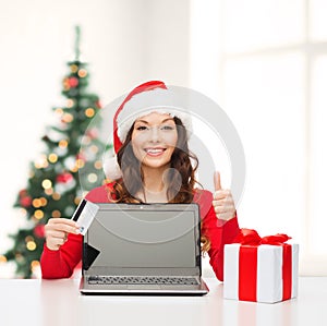 Woman with gift, laptop computer and credit card