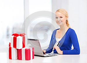 Woman with gifts, laptop computer and credit card