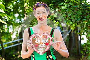 Woman with gingerbread hart in Bavaria beergarden