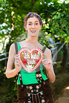 Woman with gingerbread hart in Bavaria beergarden