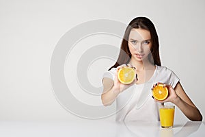 Woman girl with fruits oranges on gray white background orange