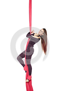 Woman girl gymnast acrobat practicing aerial air yoga acrobatics in studio isolated
