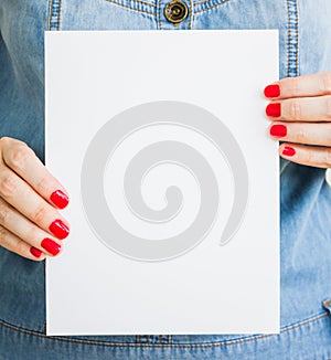 Woman, girl holds blank white paper. Mockup of the Leaflet, announcement, presentation. Sheet template