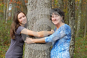 Woman and Girl Hugging Tree