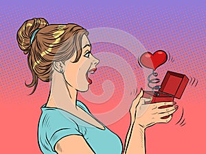 a woman girl looks at a red heart box valentine surprise greeting, love romance