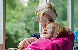 Woman and girl near the window