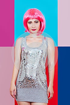 Woman girl pink hair silver dress background multicolored graphic red blue portrait beauty tenderness disco deadpen emotions