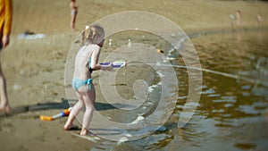 Woman with a girl playing in the river