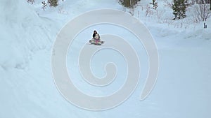 Woman and Girl Riding Fast on a Sledding Tubing
