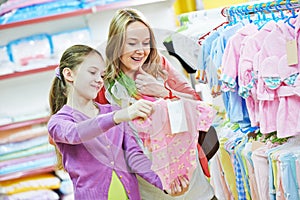 Woman and girl shopping clothes