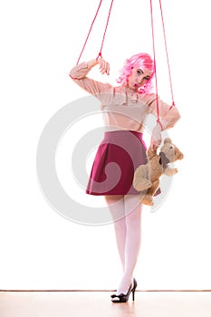 Woman girl stylized like marionette puppet on string