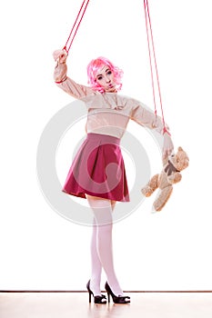 Woman girl stylized like marionette puppet on string