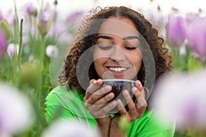 Woman Girl Teenager Field of Flowers Drinking Cup of Coffee or Tea