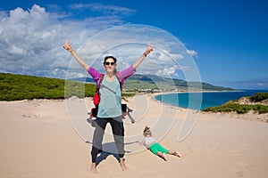 Woman and girl on top of the dune of Bolonia Beach in Cadiz photo