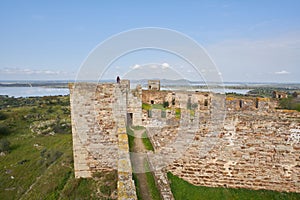 Woman girl traveler in Mourao castle towers and wall historic building in Alentejo, Portugal photo
