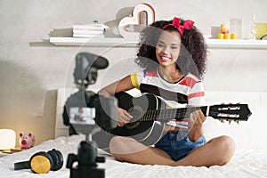 Woman Girving Guitar Class On Internet With Video Tutorial photo