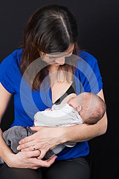 Woman gives breast to her new born baby breastfeeding