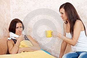 Woman gives cup to unwell friend