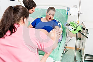 Woman giving birth in labor room of hospital