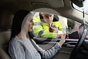 Woman giving bribe to police officer out of car window