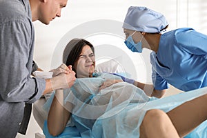 Woman giving child birth in hospital