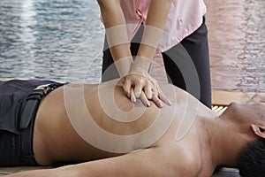 Woman giving CPR to drowning man, CPR life saving