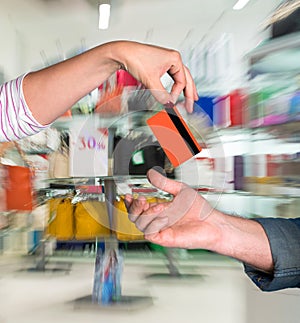 Woman giving credit card to man