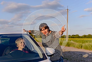 Woman giving directions to a lost driver