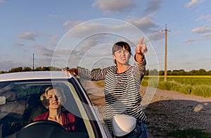 Woman giving directions to a lost driver