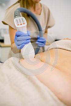 Woman giving fat reducing treatment