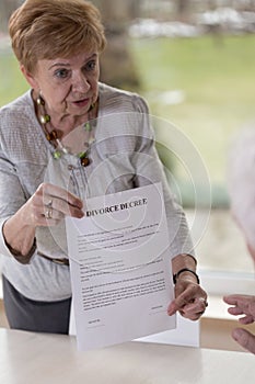 Woman giving husband divorce paper