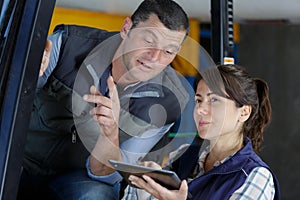 woman giving instructions to forklift driver