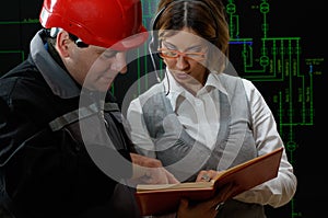 Woman is giving instructions to worker in power plant