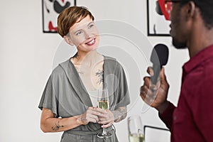 Woman Giving Interview at Art Gallery Opening