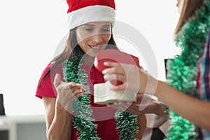 Woman giving present to best friend in beautiful red box