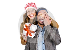 Woman giving a surprise gift to her man