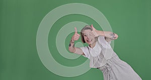 Woman giving thumbs up gesture and disappearing over green background