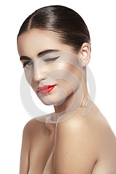 Woman with glamour red lips make-up, clean skin. Smiling and winking