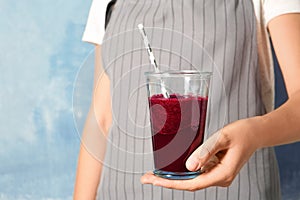 Woman with glass of beet smoothie