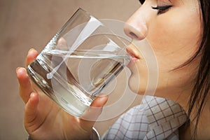 Woman with glass of mineral water