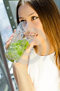 Woman with glass of mojito drink